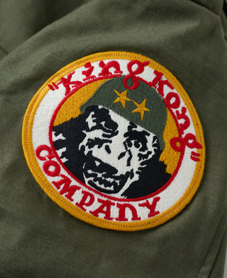 Olive field jacket embroidered round patch with multicolor lettering