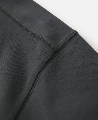 Dark gray hem stitch and sleeve seam close-up