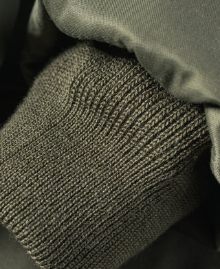 Olive flight jacket knit cuff and collar seam detail.