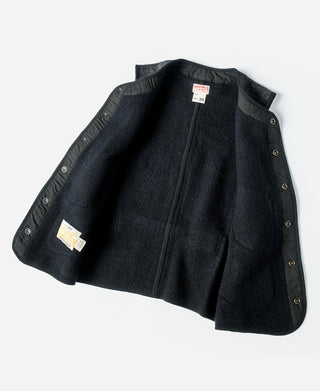 Dark salt-and-pepper wool vest laid flat with flap pockets and button front