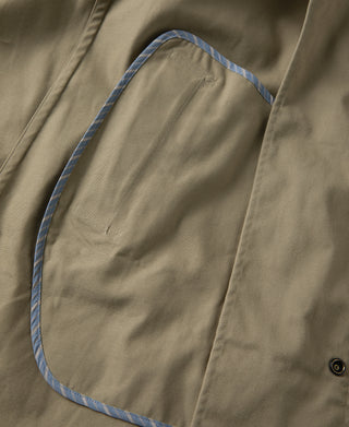 Khaki all-weather trench coat pocket edge with blue contrast trim