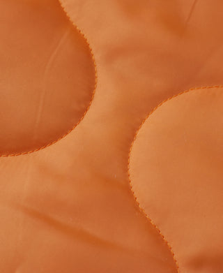 Orange quilted lining fabric inside the helmet bag