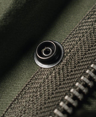 Olive field jacket snap button and textured fabric weave, side close-up