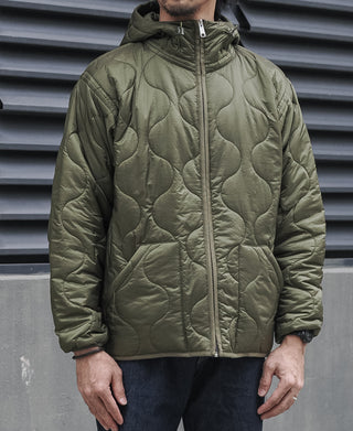 Olive hooded quilted jacket with full zipper and curved quilting panels