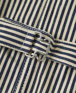 Striped vest belt detail with metal buckle ring and loop
