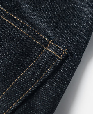Indigo selvedge denim jeans detail with orange thread topstitching and seam