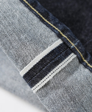 Indigo selvedge denim jeans back yoke with woven label patch and contrast stitching