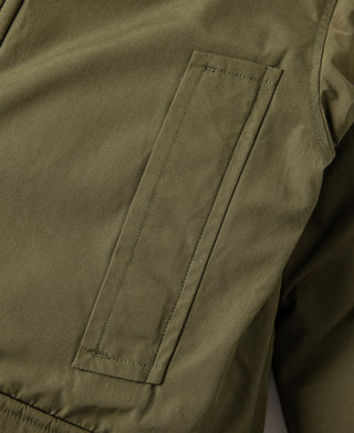 Olive parka side pocket with flap and clean stitched panel details