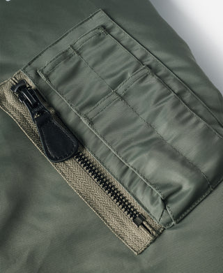 Olive MA-1 flight jacket, zippered pocket with snap flap and black pull tab