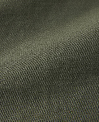 Olive fatigue utility shirt fabric close-up with fine textured weave
