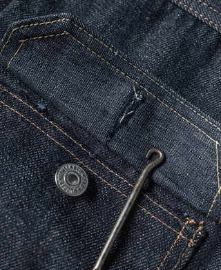 Indigo denim jacket interior placket with snap button and pocket edge