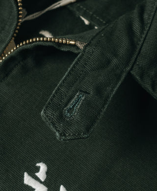 Dark green jacket chest area with embroidered fox patch and inner pocket