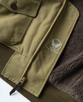 Khaki flight jacket with front zipper and Air Force emblem patch near pocket