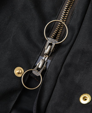 Black waxed jacket zipper pull and ring detail with gold-tone snap buttons