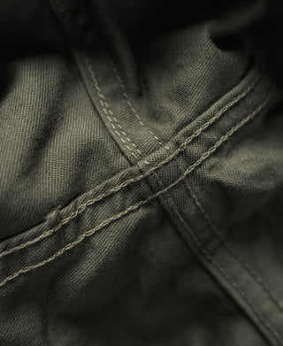 Olive fatigue utility shorts close-up of cargo pocket seams and topstitching