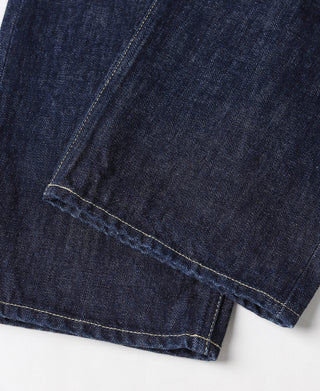 Indigo denim jeans leg with hem and contrast stitch line, close-up