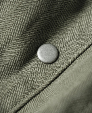 Olive fatigue jacket front with light-colored button
