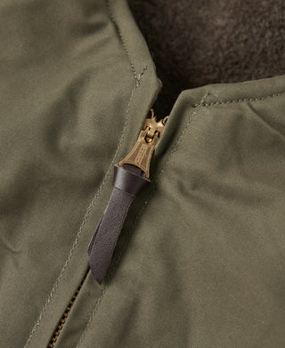 Olive zip-front vest with leather zipper pull and metal zipper ring