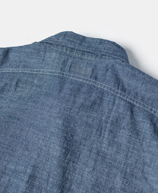 Blue chambray shirt back yoke with stitched panels and curved yoke seam.