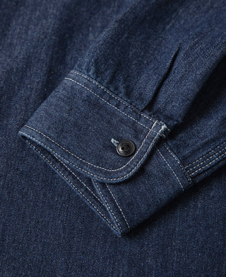 Denim workshirt cuff with round button and curved placket seam, dark blue denim