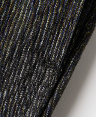 Salt-and-pepper trouser fabric texture with crease at side