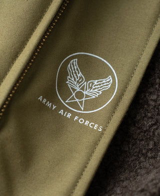 Air Force round emblem patch on khaki flight jacket chest panel