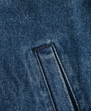 Indigo denim work jacket, close-up of zipper tab and fabric detail