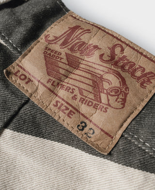Prisoner pants label patch with red print on white and dark gray striped fabric