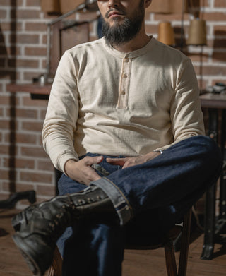 Light cream vintage henley long-sleeve shirt on a seated man, button placket visible