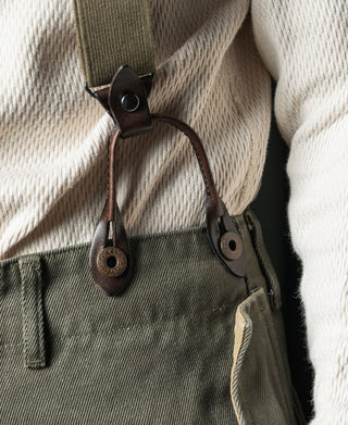 Olive webbing connector with dark leather tabs and looped metal hardware