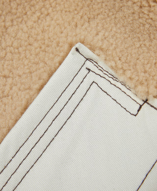 Flight jacket collar lining with cream ribbed trim and visible stitched seams