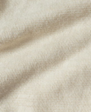 Cream knit fabric close-up with fine ribbed texture