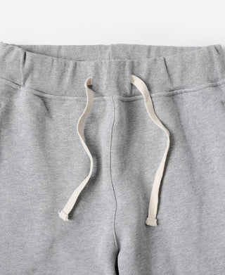 Gray heavyweight terry sweatpants with elastic waistband and drawstring ties