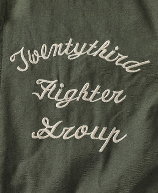Olive jacket lining with cursive script embroidery, “Everything Fighter & Devour”