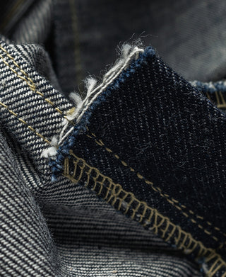 Indigo selvedge denim jeans, close-up of cuff seam with contrast yellow stitching