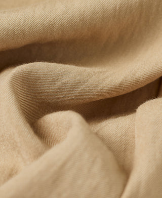 Beige inner lining fabric close-up with smooth woven texture