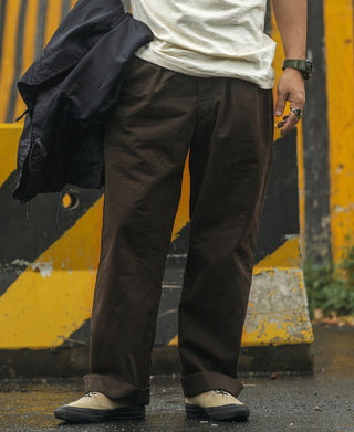 Dark brown combat pants with relaxed fit, straight legs, and cuffed hems
