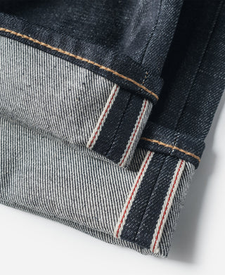 Indigo denim jeans hem with selvedge-style striped stitch reinforcement