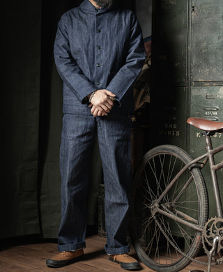 Indigo dungaree trousers worn by model, full length with button fly