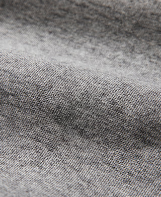 Gray knit sweater fabric close-up with fine heather texture