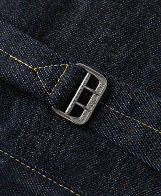 Indigo denim jacket strap closure with silver buckle hardware and yellow stitch line