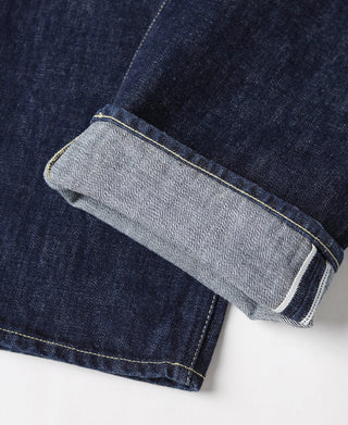 Indigo selvedge denim jeans with light-colored inner cuff and contrast edging, close-up