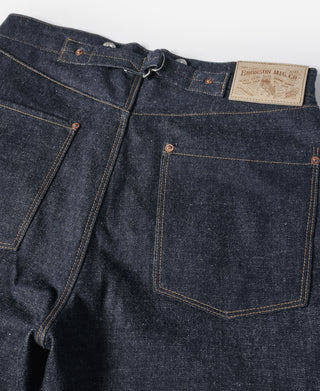 Indigo selvedge denim jeans—front waistband with leather brand patch and button fly