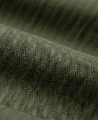 Olive HBT fabric fatigue trousers, close-up texture and diagonal weave