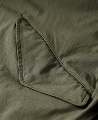 Olive parka sleeve with stitched pocket seam detail