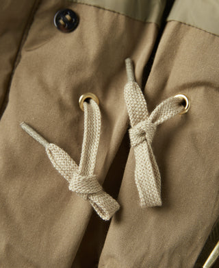 Khaki parka with beige drawstring cords and metal eyelets