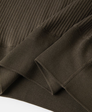 Ribbed cuff and sleeve seam detail on olive-brown henley