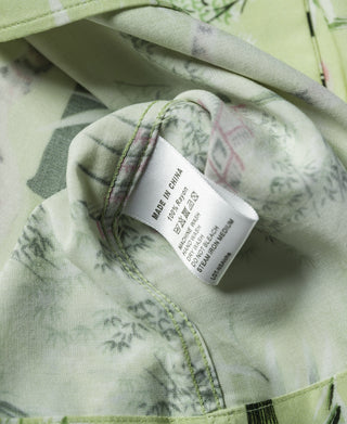 Light green aloha shirt interior fabric with size label near stitched placket