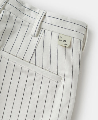 White pinstripe work pants with belt loops, fly area, and size tag
