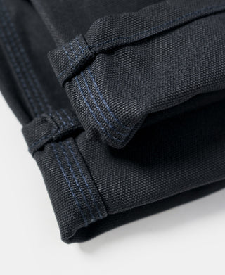 Navy canvas pant hem with reinforced stitching and folded cuff detail